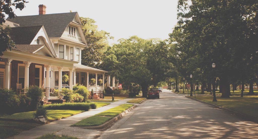 house on street with trees