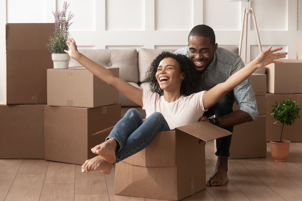 Happy Couple Unpacks Boxes in their First-Time Home Purchase