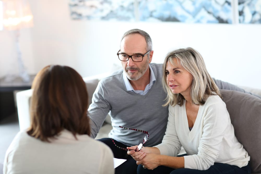 Couple Sits Down To Talk With Insurance Agents