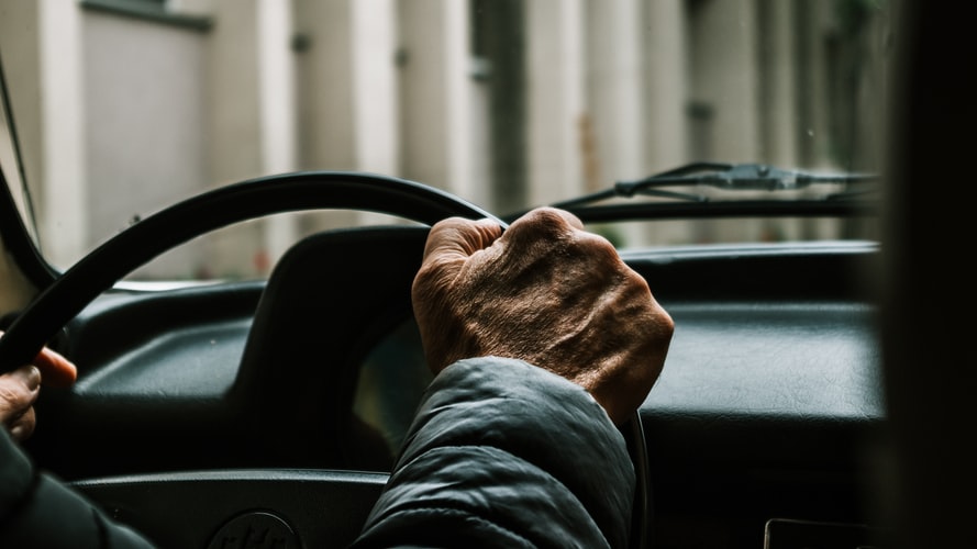 Man Of Older Age Has Hands on Steering Wheel