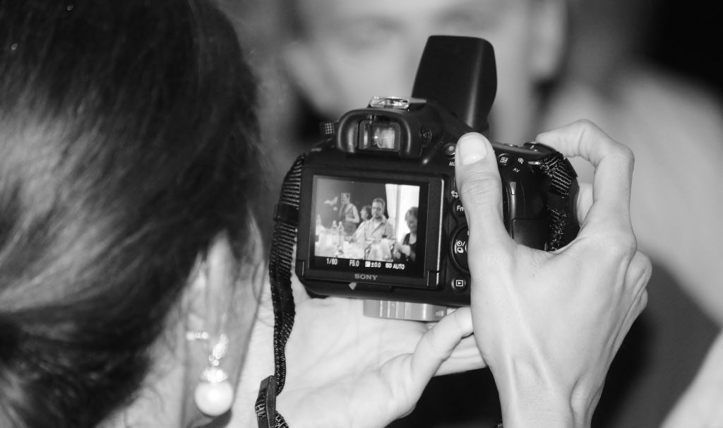 Woman Taking a Photo at a Wedding