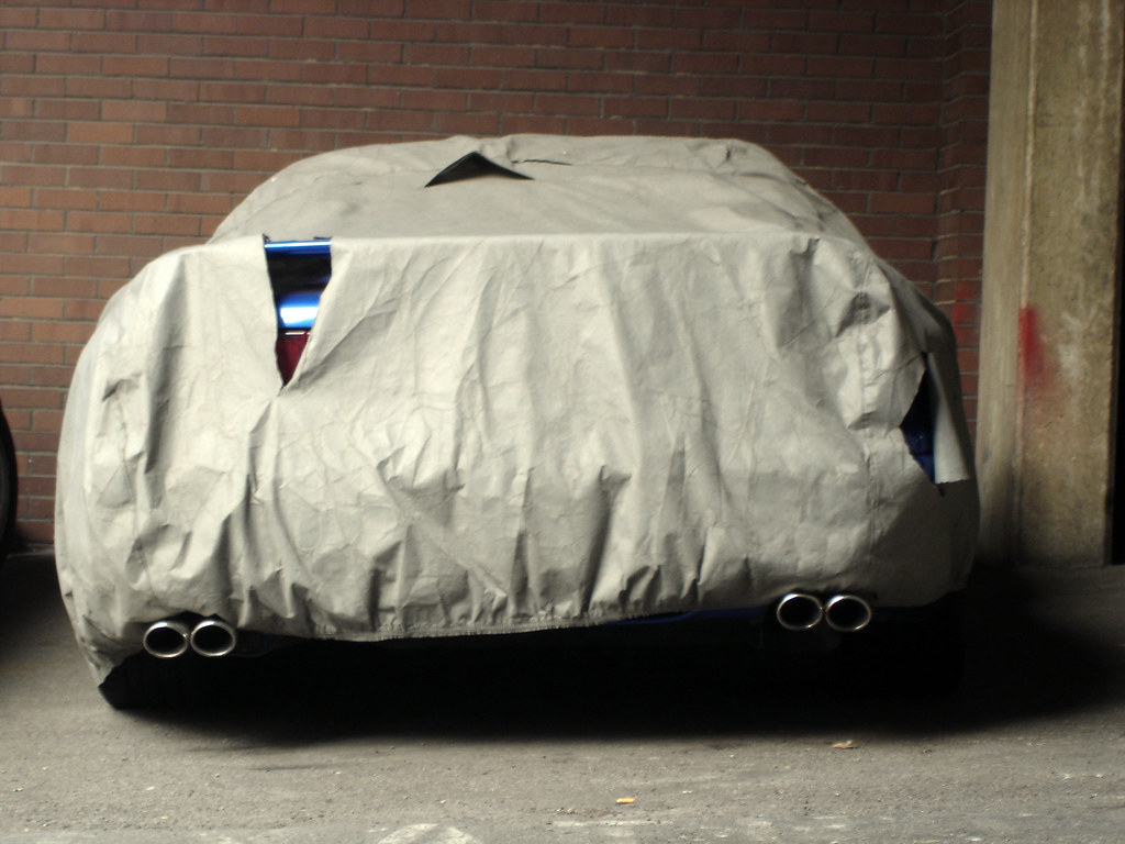 Blue Sports Car Under Tarp For Storage