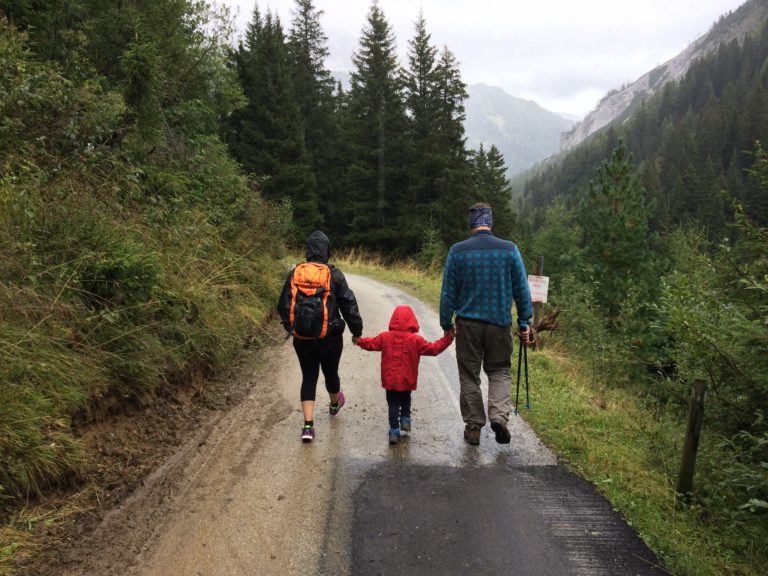 Family walking in the rain