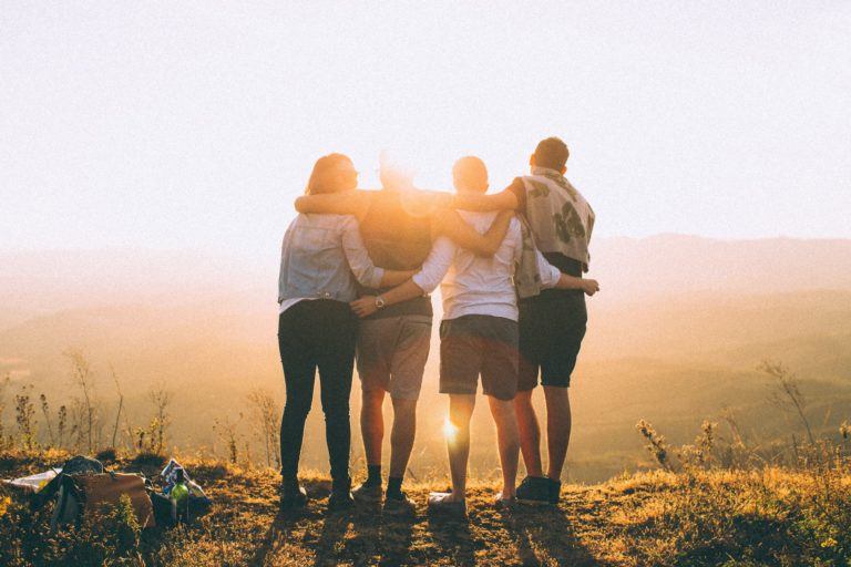 Friends hiking under the sunset