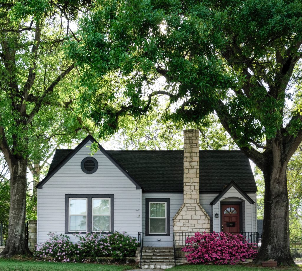 White house with chimney and brown wood door