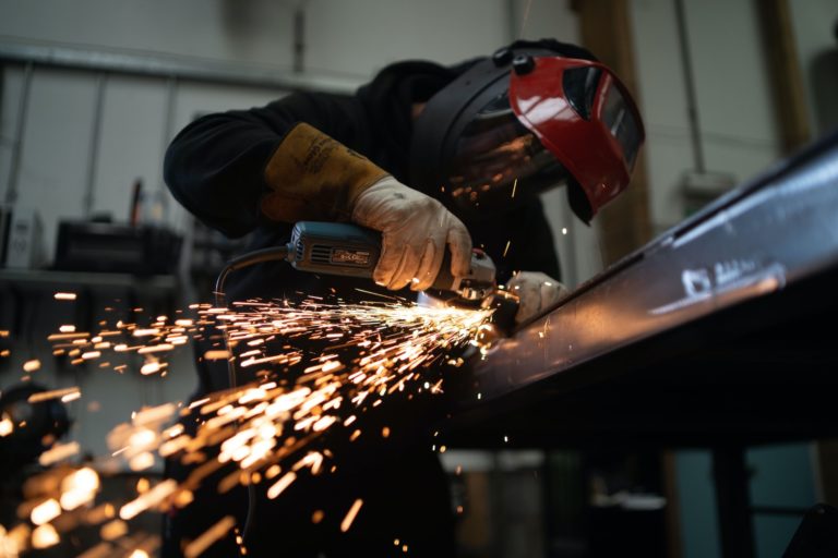 welder in mask with sparks