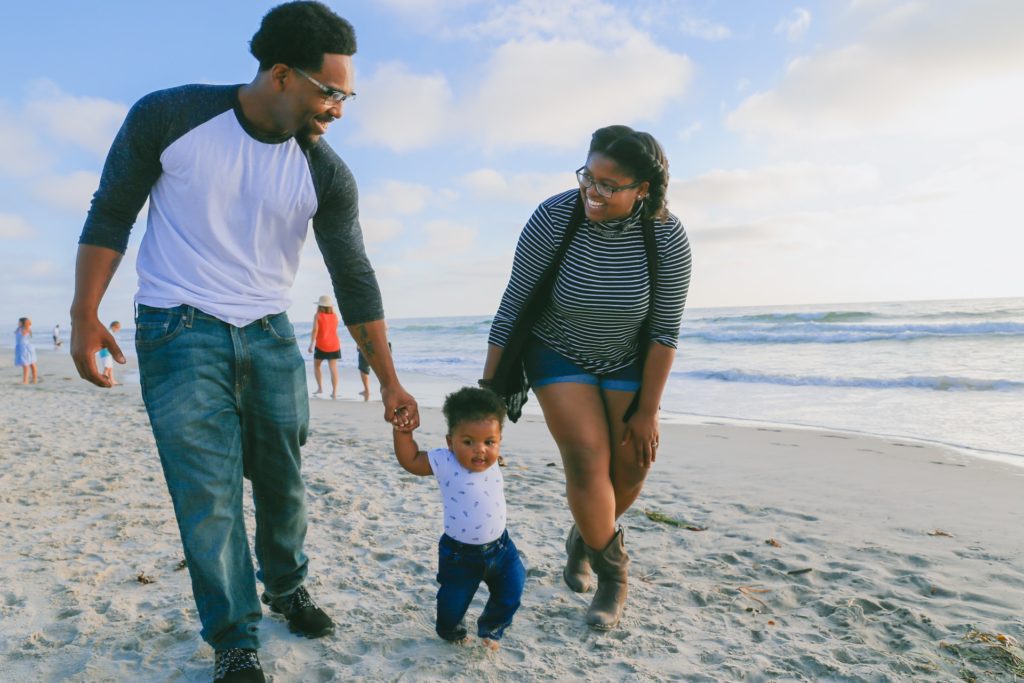 parents and young child on a beach