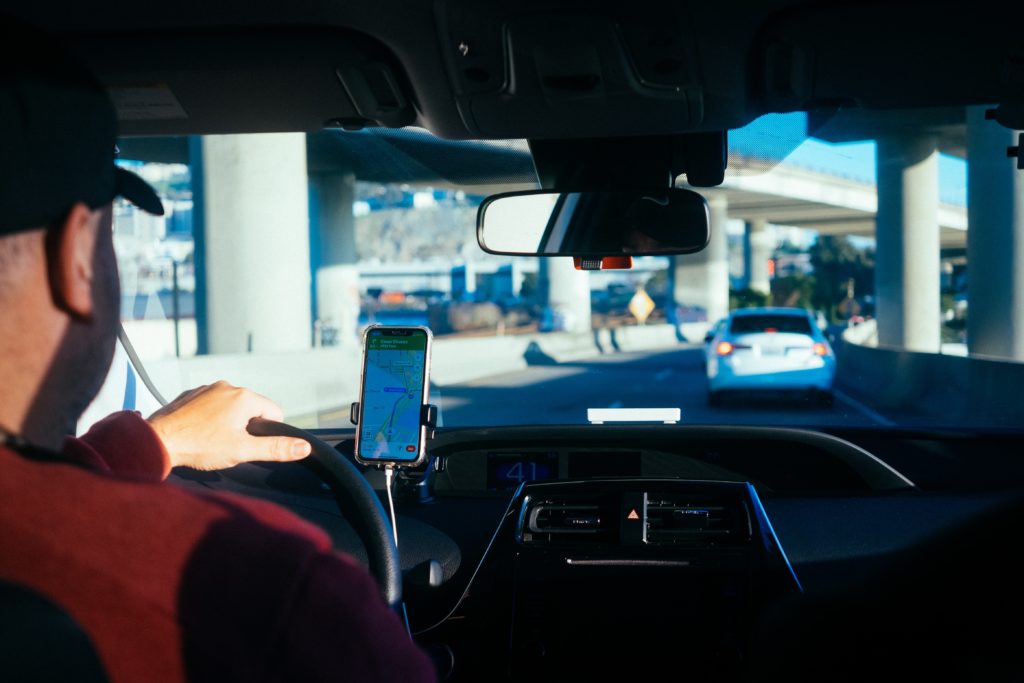Man driving using phone as GPS