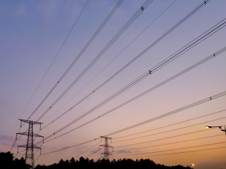 telephone wires in front of a sunset